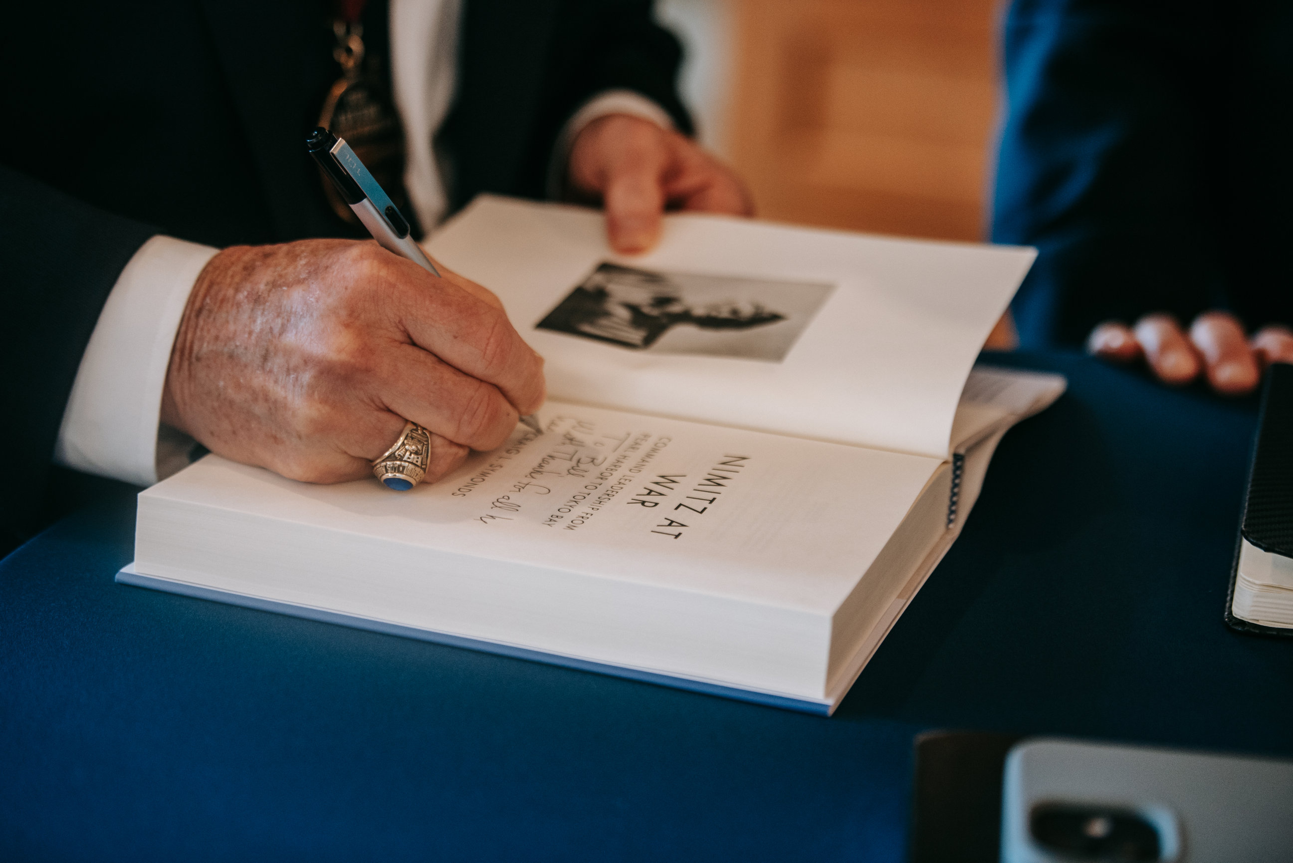 Craig Symonds signs a copy of book