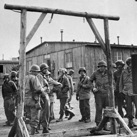 American Soldiers View a Gallows Erected Between Rows of Barracks in the Ohrdruf Concentration Camp
