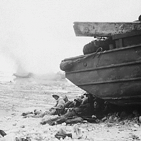 An Amphibious Tractor Burns as Marines Take Shelter After Landing on Peleliu