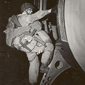 Technician Fourth Grade Joseph F. Gorenc of 3rd Battalion, 506th Parachute Infantry Regiment, 101st Airborne Division Boards a C-47 