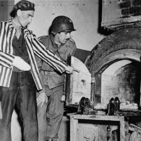 A Polish Survivor Shows U.S. Soldier John L. Lyndon the Crematorium Ovens Used to Burn Corpses at Dora-Mittelbau Concentration Camp