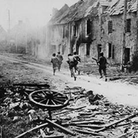 American Soldiers Run through a Severely Damaged French Village