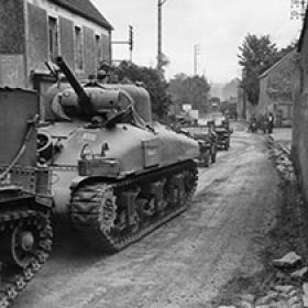 American Tanks and Jeeps Move through a French Village