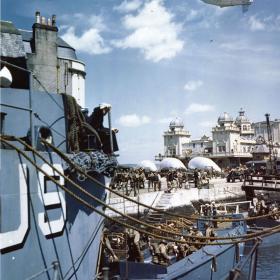 American troops at a British port descend into barges which will take them to troop to Hitler's Fortress Europe.