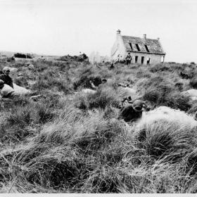 American soldiers who have pushed forward from the beaches, dig themselves in against counterattack in the fields inland. This is the original of a radio previously serviced.